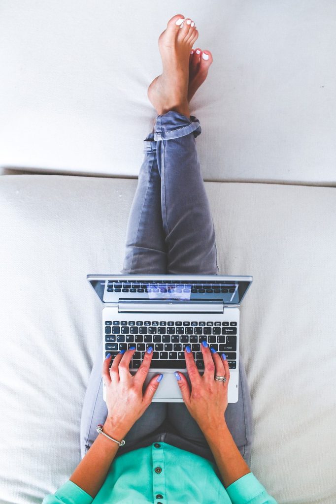 Woman on lap top on the couch