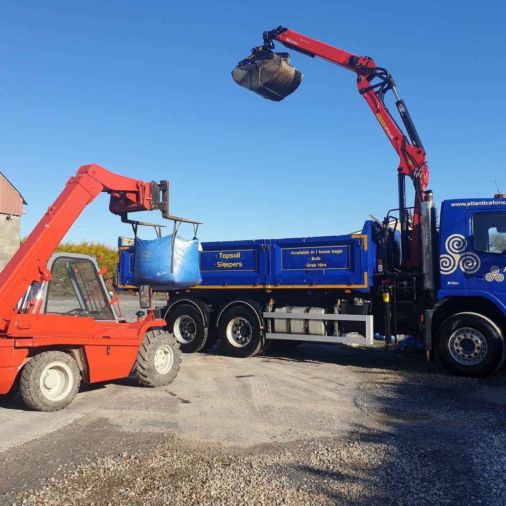 Using a teleporter to load a blue Atlantic Stone grab truck with a 1 ton bag of decorative stone in Galway